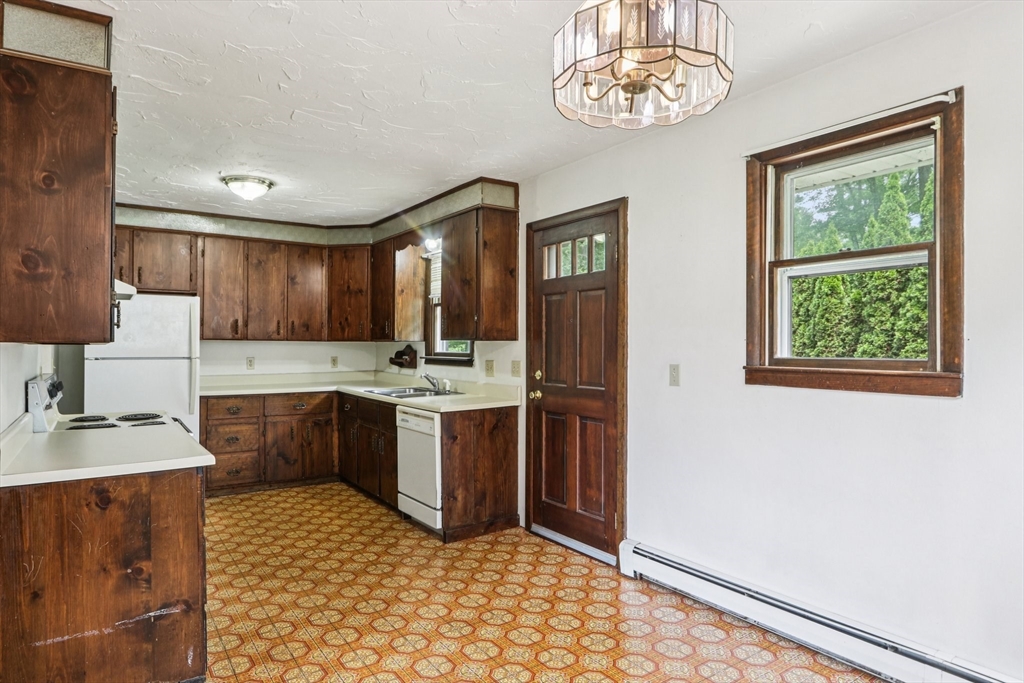 16 Indian Run Road Bellingham, MA 02019 - Photo 10 of 34 a kitchen with stainless steel appliances granite countertop a sink stove and refrigerator