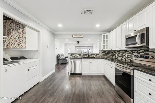 a kitchen with granite countertop a stove and a refrigerator