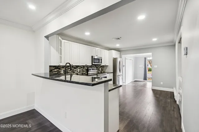a view of a livingroom with furniture and wooden floor