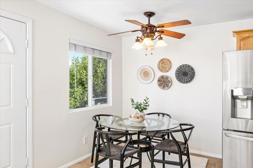 868 East Alvarado Street, Unit 27 Fallbrook, CA 92028 - Photo 5 of 20 a view of a dining room that has a table and a chandelier
