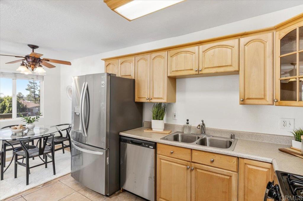 868 East Alvarado Street, Unit 27 Fallbrook, CA 92028 - Photo 6 of 20 a kitchen with stainless steel appliances a refrigerator sink and cabinets