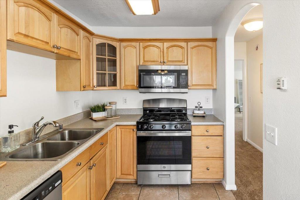 868 East Alvarado Street, Unit 27 Fallbrook, CA 92028 - Photo 7 of 20 a kitchen with stainless steel appliances granite countertop a stove and a sink