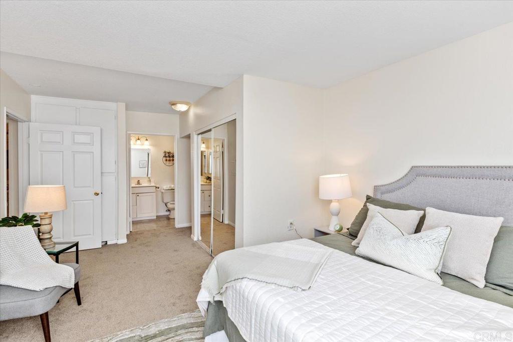 868 East Alvarado Street, Unit 27 Fallbrook, CA 92028 - Photo 8 of 20 a bedroom with a bed and a lamp