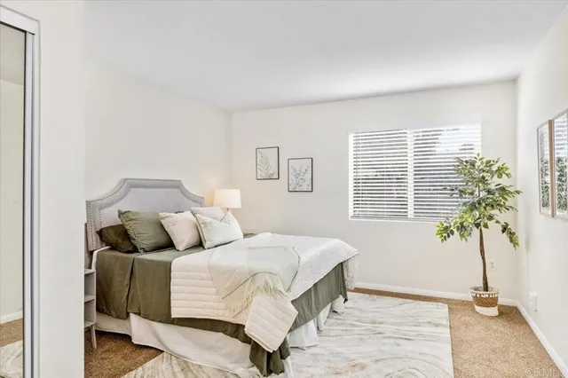 a bedroom with a bed and a potted plant