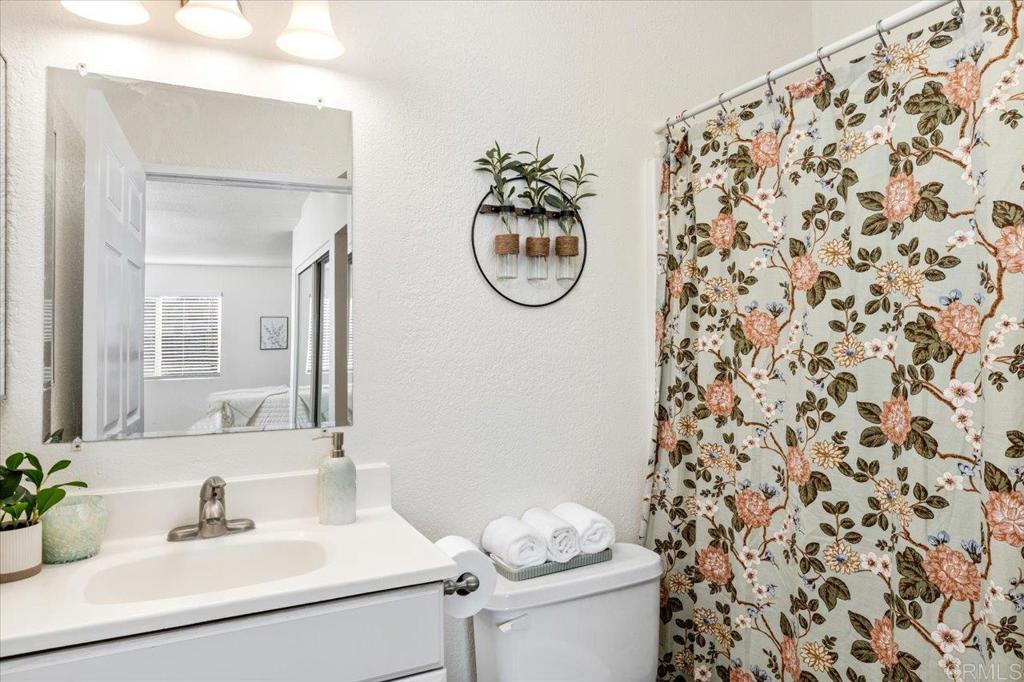 868 East Alvarado Street, Unit 27 Fallbrook, CA 92028 - Photo 10 of 20 a bathroom with a sink toilet and a mirror