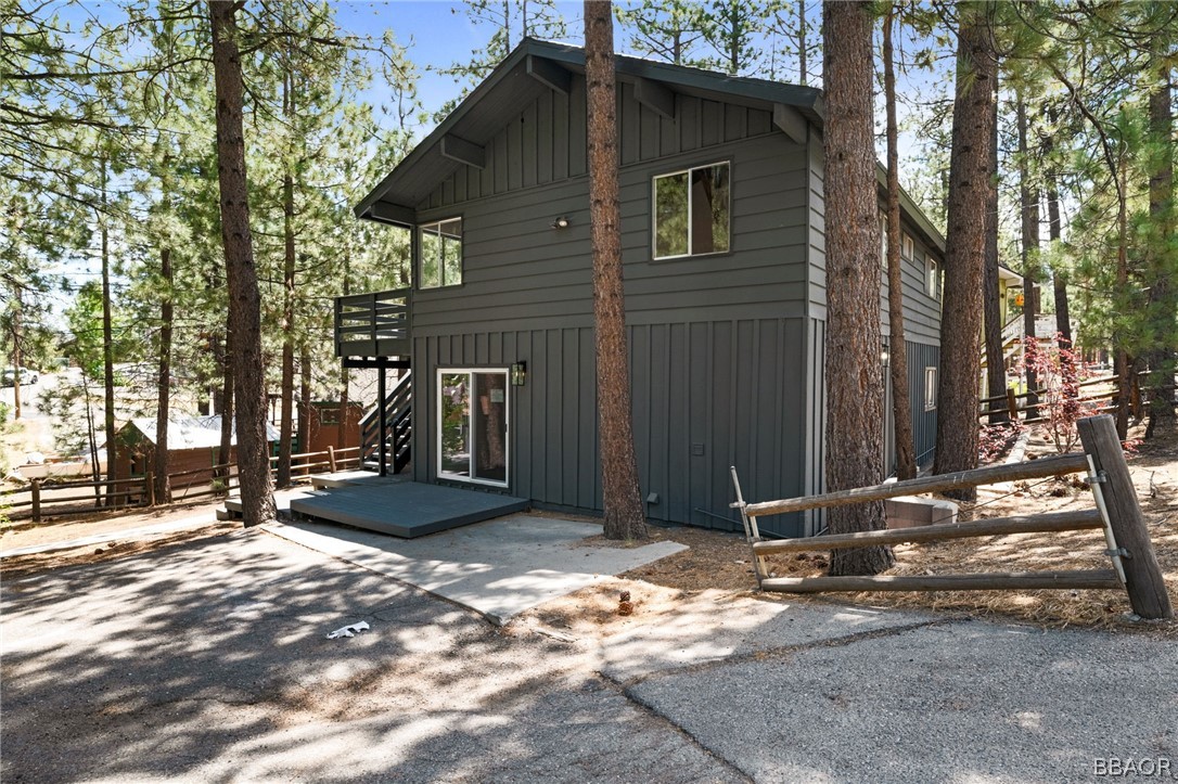 39596 Forest Road Big Bear Lake, CA 92315 - Photo 17 of 50 a view of a house with a door and wooden fence