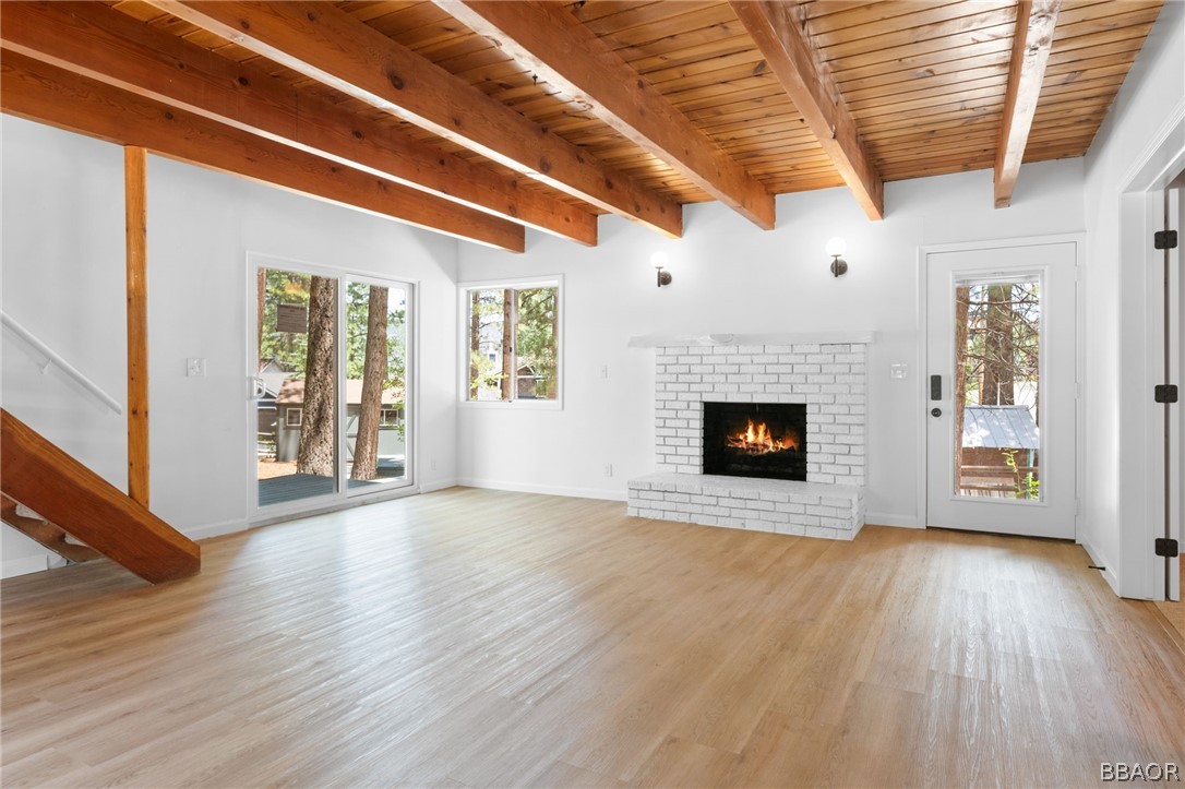 39596 Forest Road Big Bear Lake, CA 92315 - Photo 24 of 50 a view of an empty room with wooden floor fireplace and a window