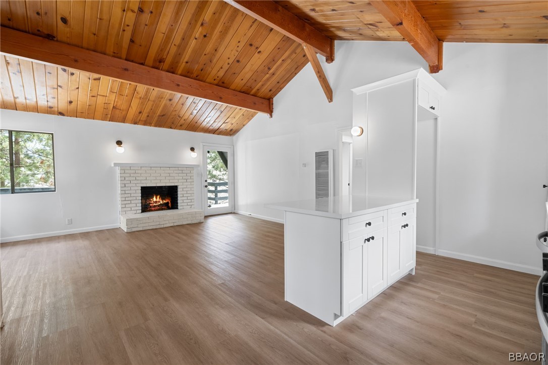 39596 Forest Road Big Bear Lake, CA 92315 - Photo 32 of 50 a view of a livingroom with wooden floor and a fireplace