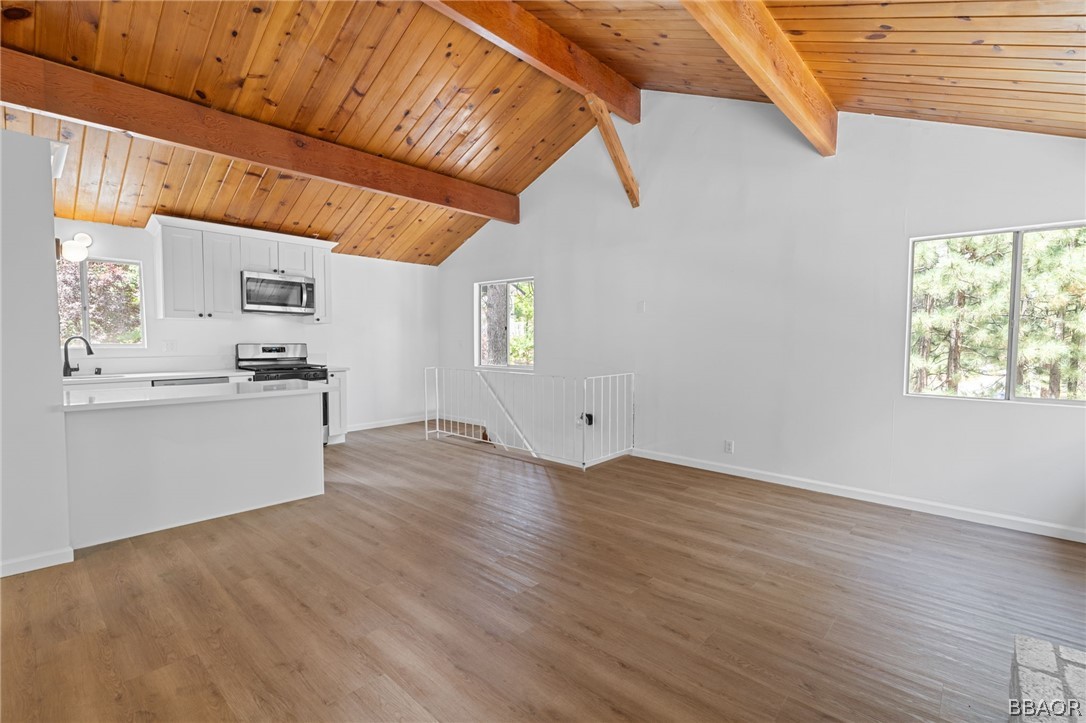 39596 Forest Road Big Bear Lake, CA 92315 - Photo 36 of 50 a view of a kitchen with wooden floor and an empty room
