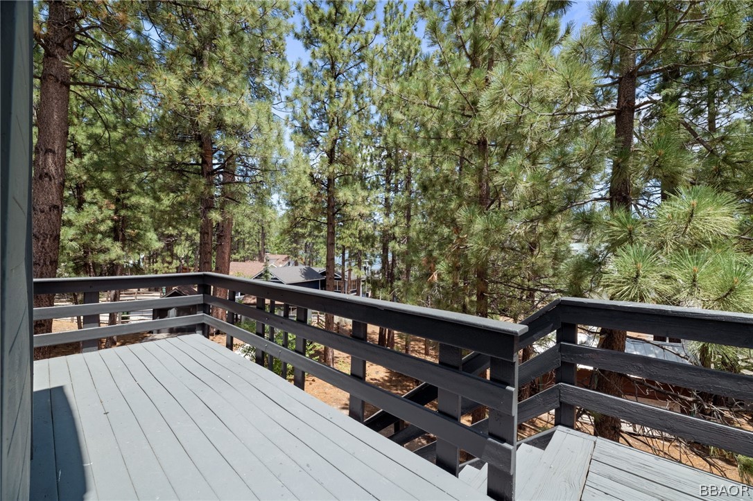 39596 Forest Road Big Bear Lake, CA 92315 - Photo 44 of 50 a view of a roof deck with wooden floor and fence