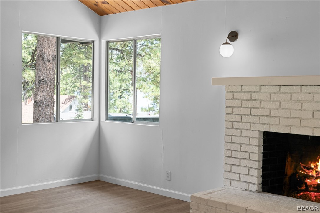 39596 Forest Road Big Bear Lake, CA 92315 - Photo 47 of 50 a view of an empty room with a fireplace and a window
