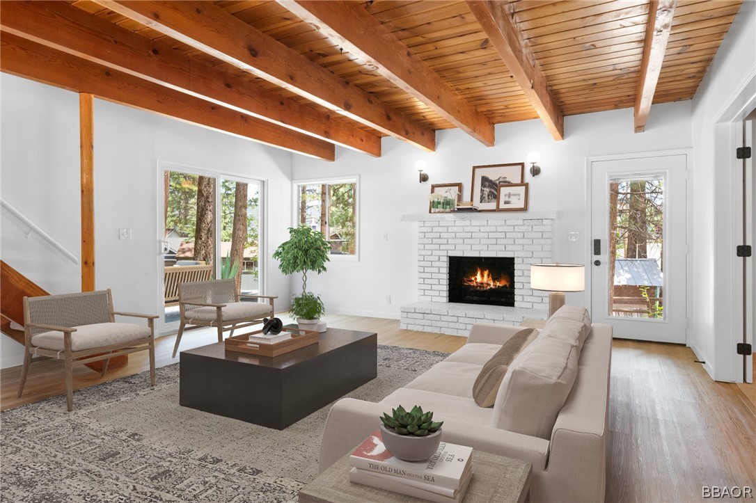 39596 Forest Road Big Bear Lake, CA 92315 - Photo 8 of 50 a living room with furniture wooden floor and a fireplace