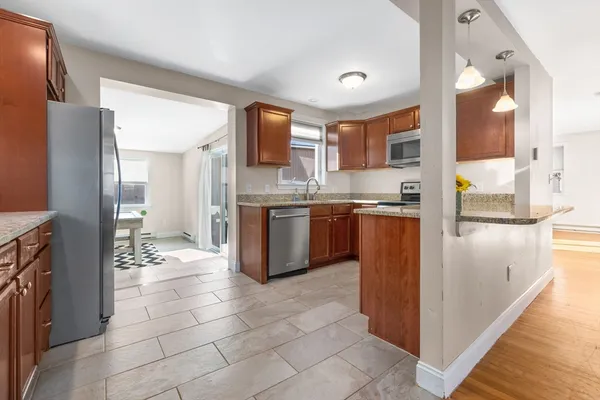 a kitchen with stainless steel appliances granite countertop a refrigerator and a sink