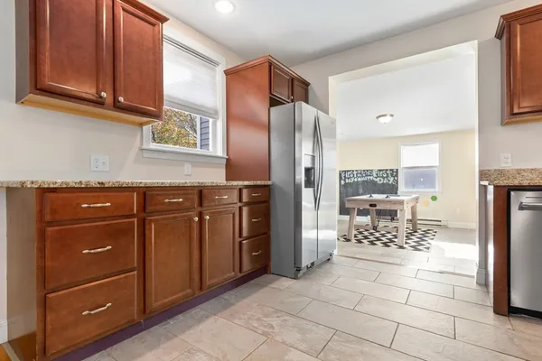a kitchen with stainless steel appliances granite countertop a refrigerator and a stove top oven