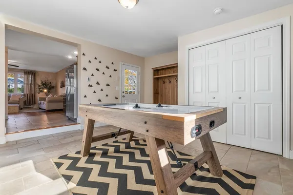 a room with table chairs and cabinets