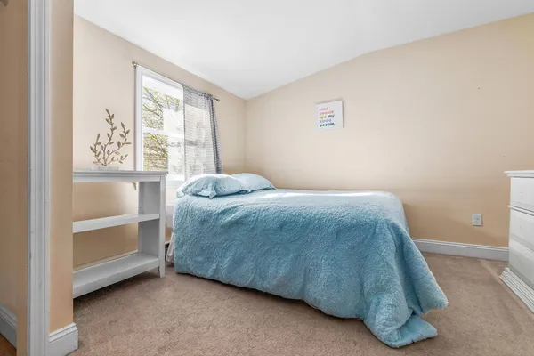 a bed sitting in a room next to a window