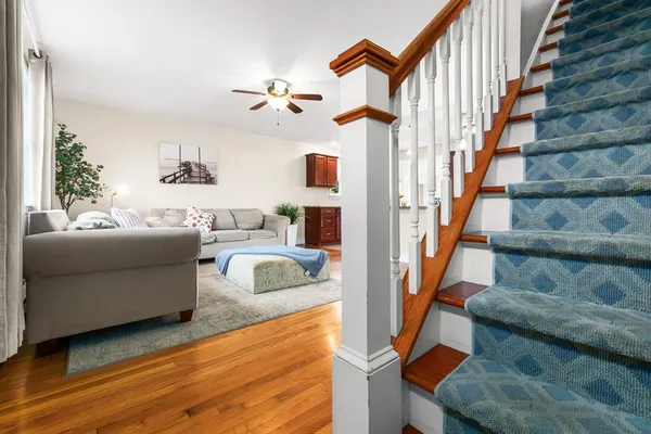a living room with furniture and a stair
