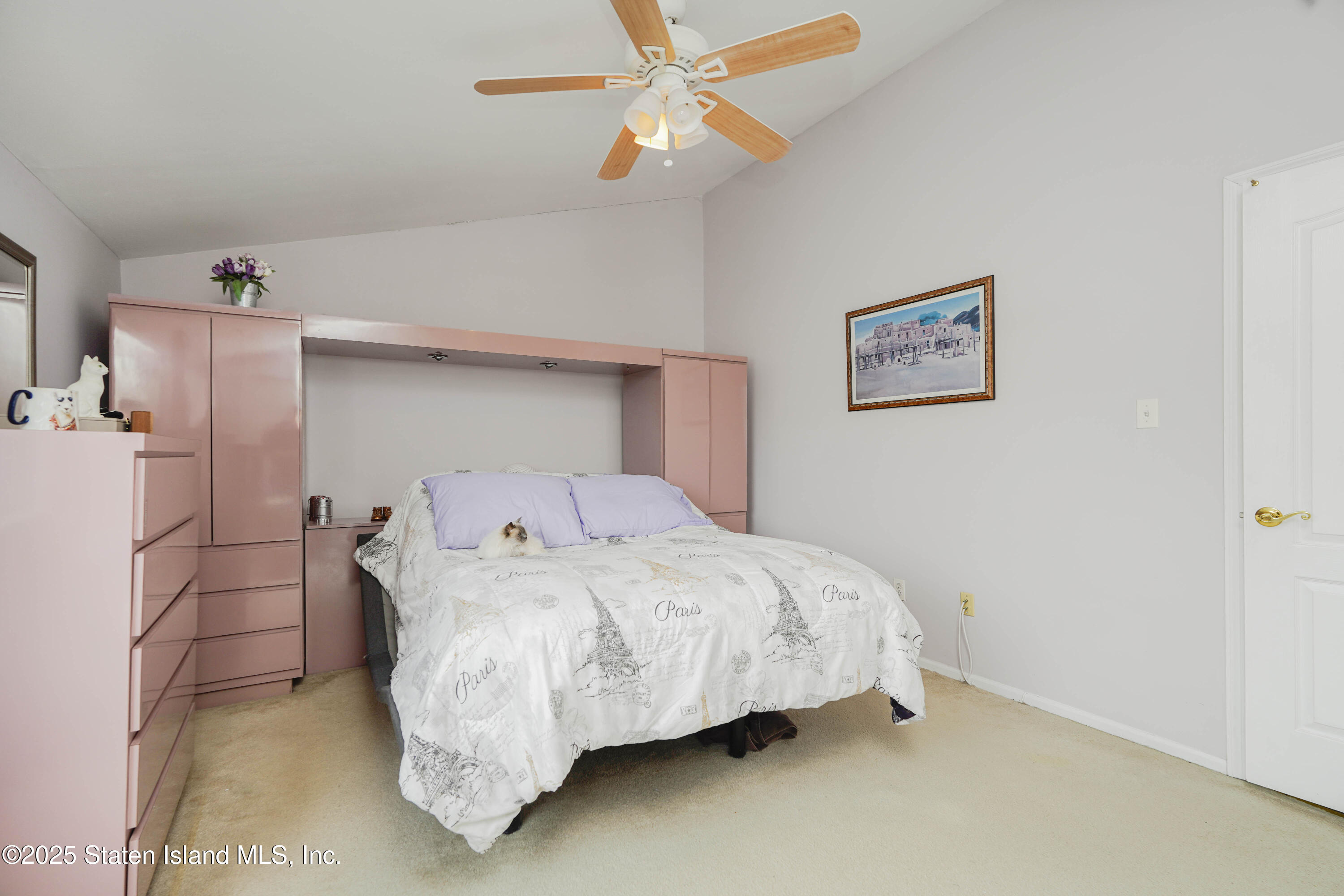 119 Glenn Road Staten Island, NY 10314 - Photo 11 of 26 a bedroom with a bed and a refrigerator
