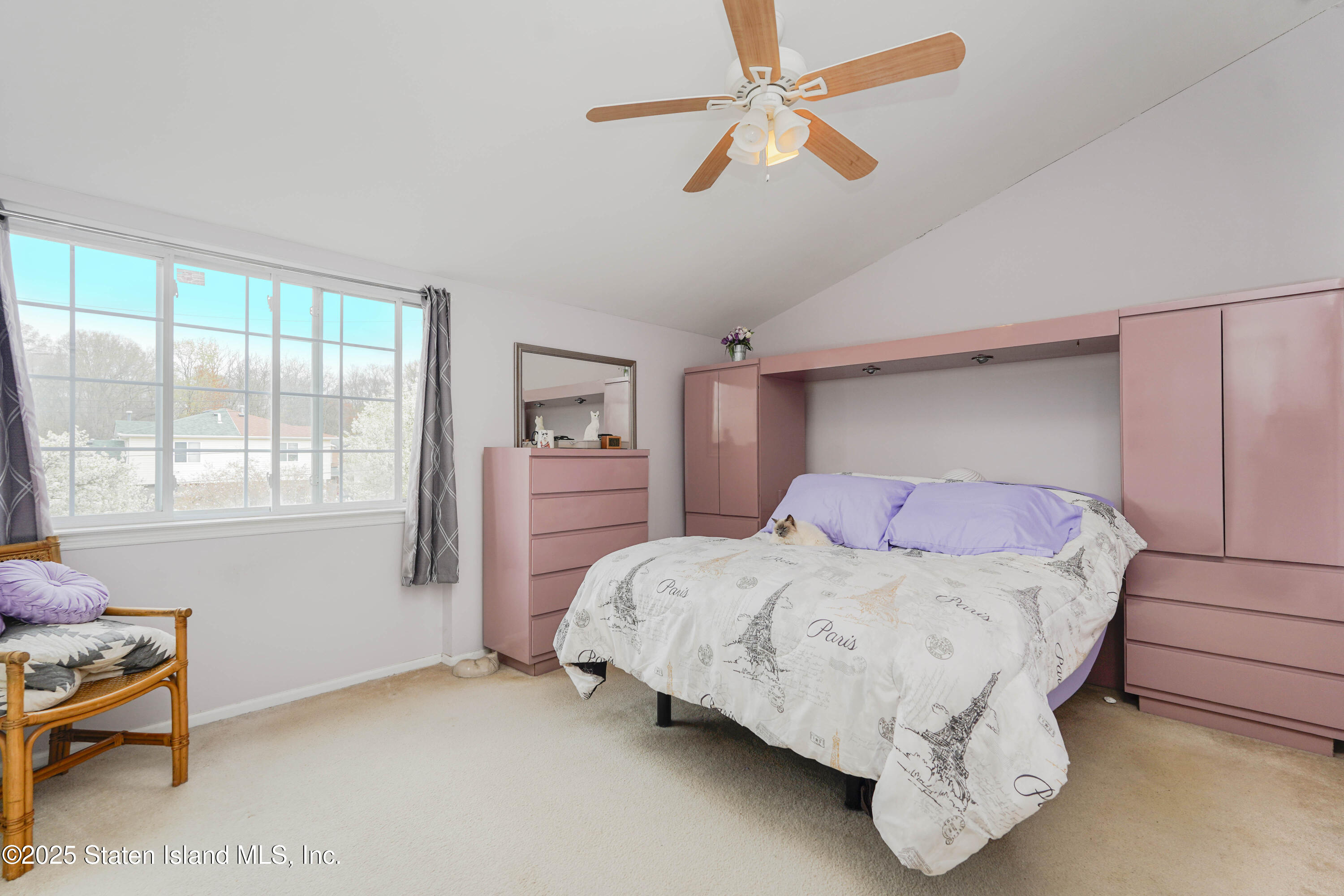 119 Glenn Road Staten Island, NY 10314 - Photo 12 of 26 a bedroom with a bed and a chandelier