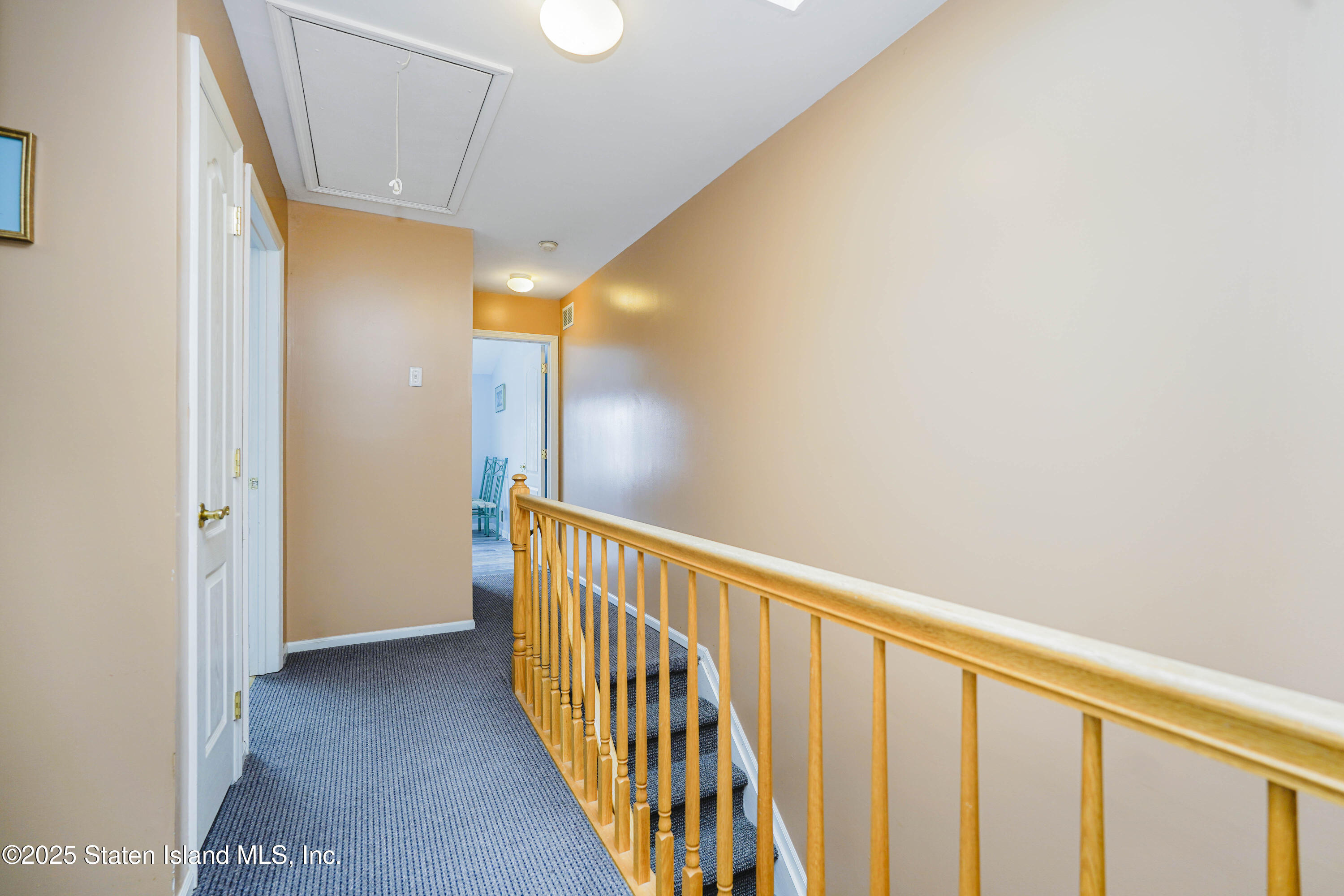 119 Glenn Road Staten Island, NY 10314 - Photo 13 of 26 a view of a hallway with wooden floor