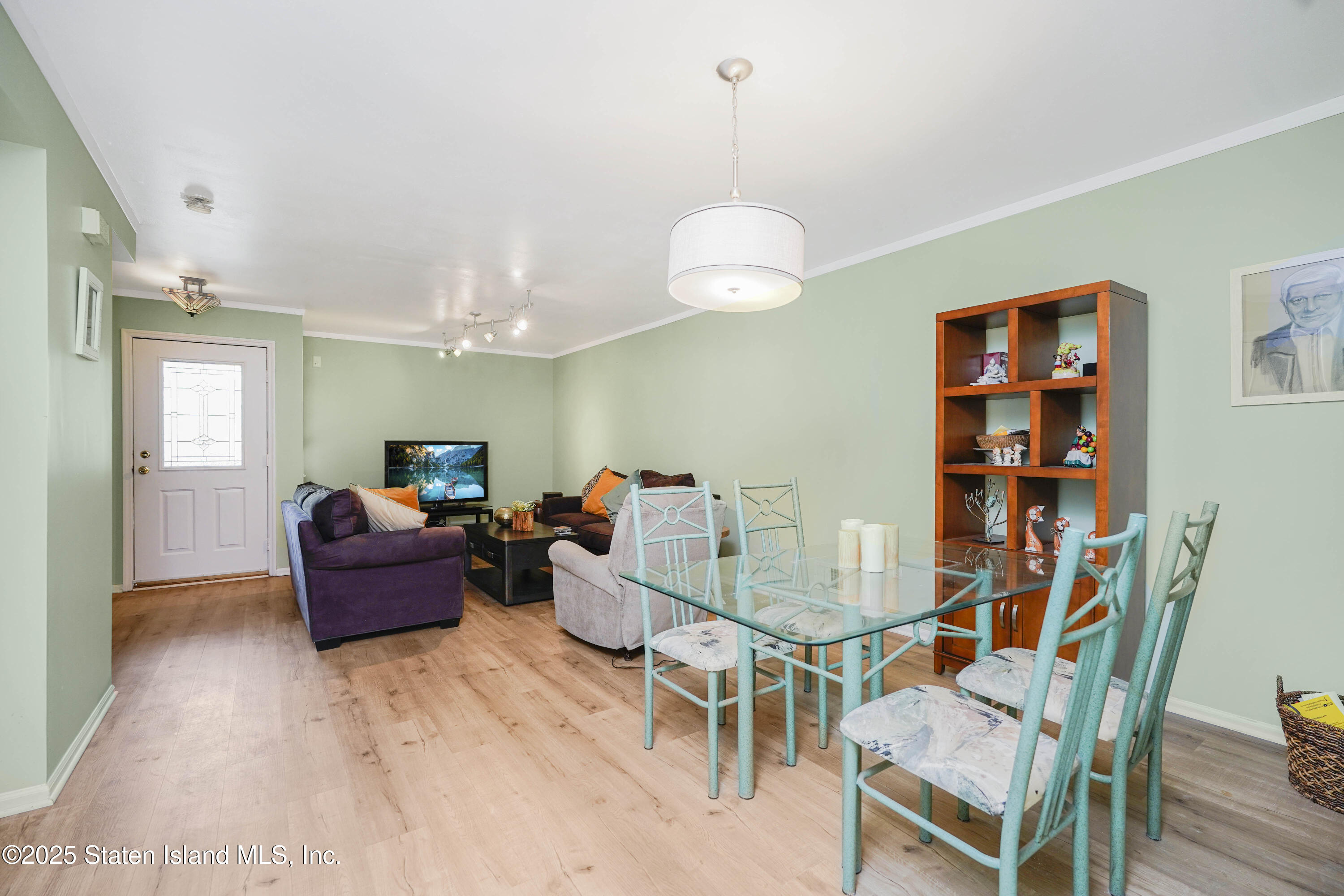 119 Glenn Road Staten Island, NY 10314 - Photo 2 of 26 a living room with furniture and wooden floor