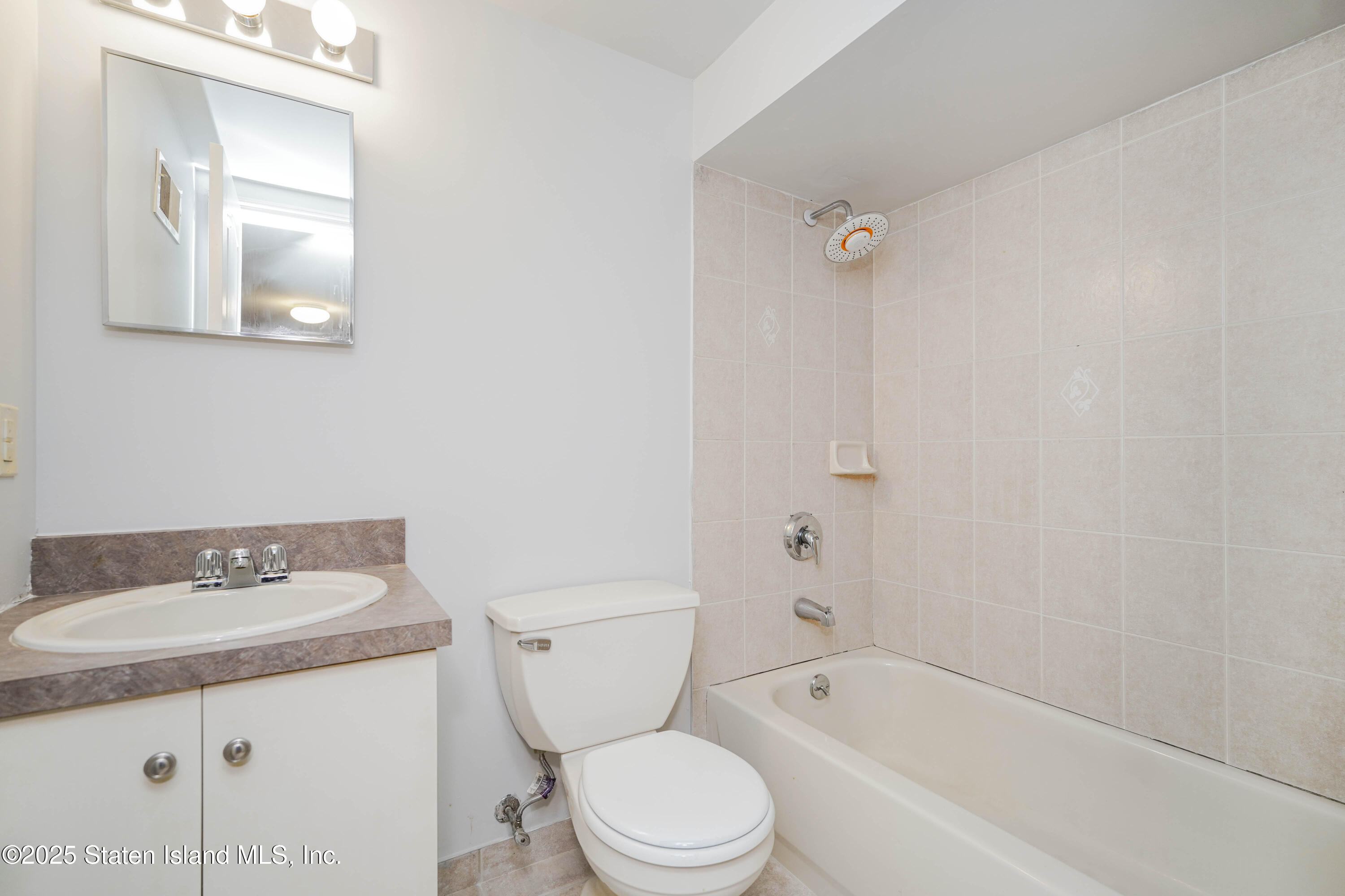 119 Glenn Road Staten Island, NY 10314 - Photo 23 of 26 a bathroom with a sink toilet and shower