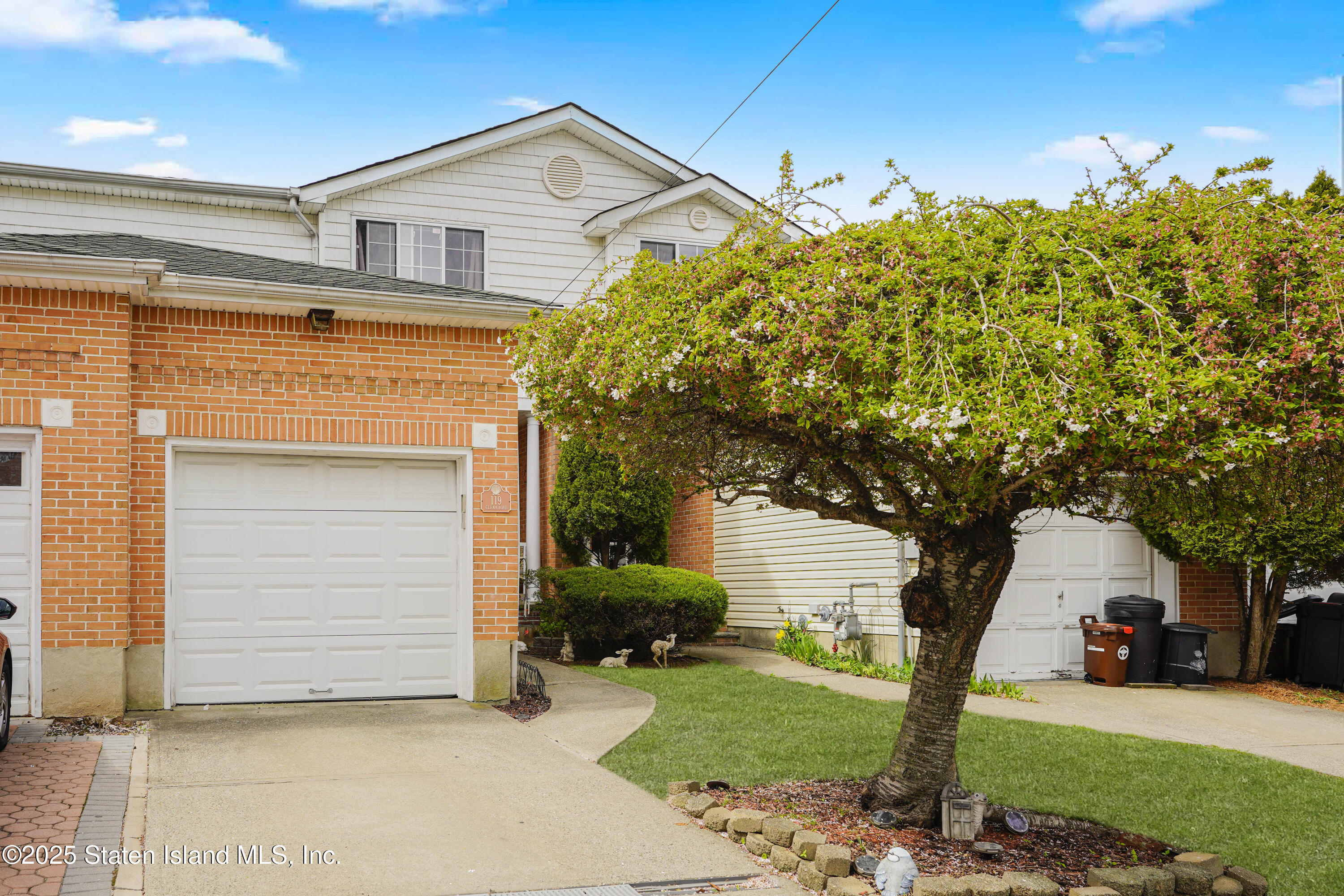 119 Glenn Road Staten Island, NY 10314 - Photo 26 of 26 a front view of a house with a yard and garage