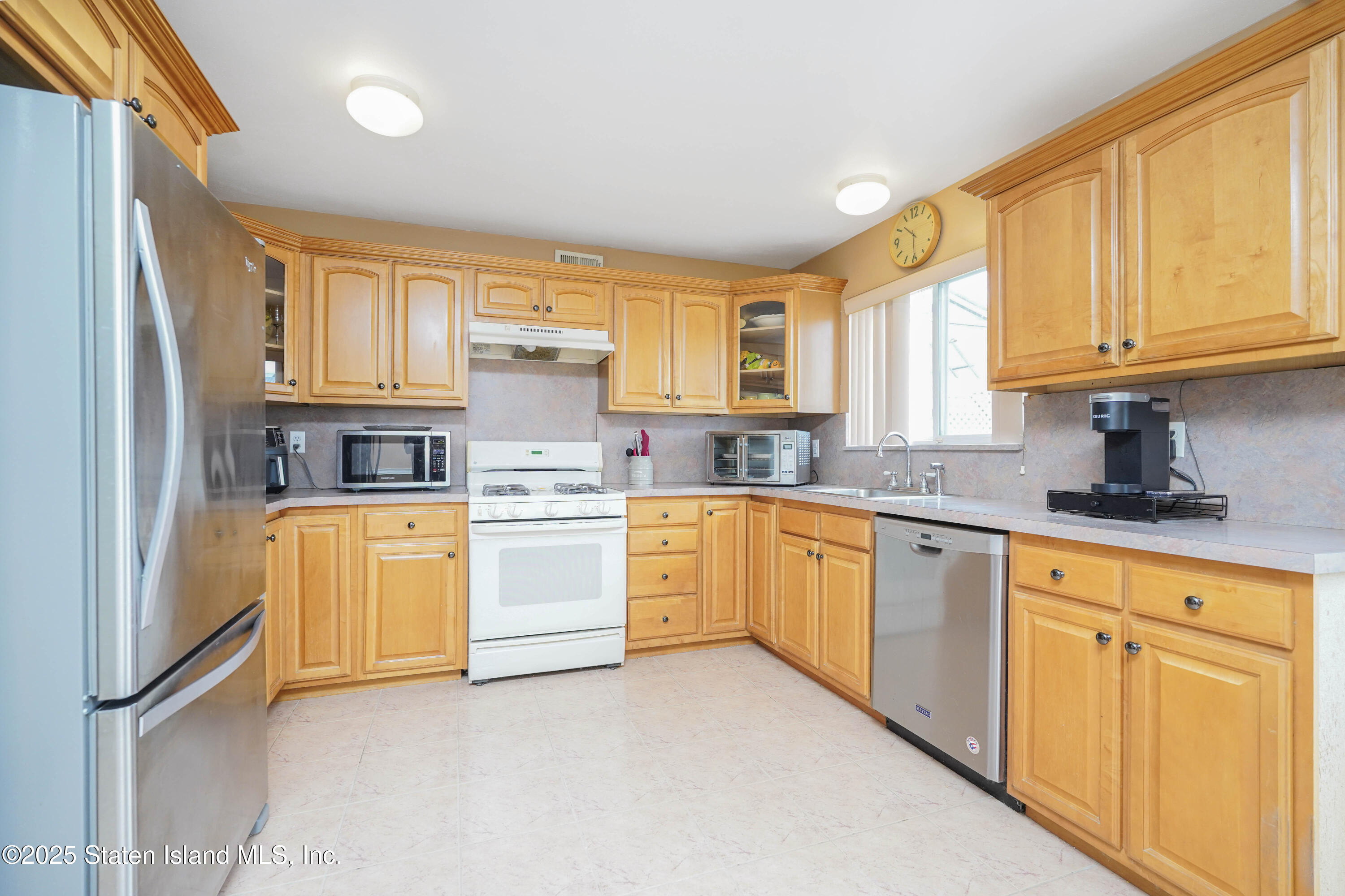 119 Glenn Road Staten Island, NY 10314 - Photo 5 of 26 a kitchen with stainless steel appliances granite countertop a refrigerator sink and cabinets