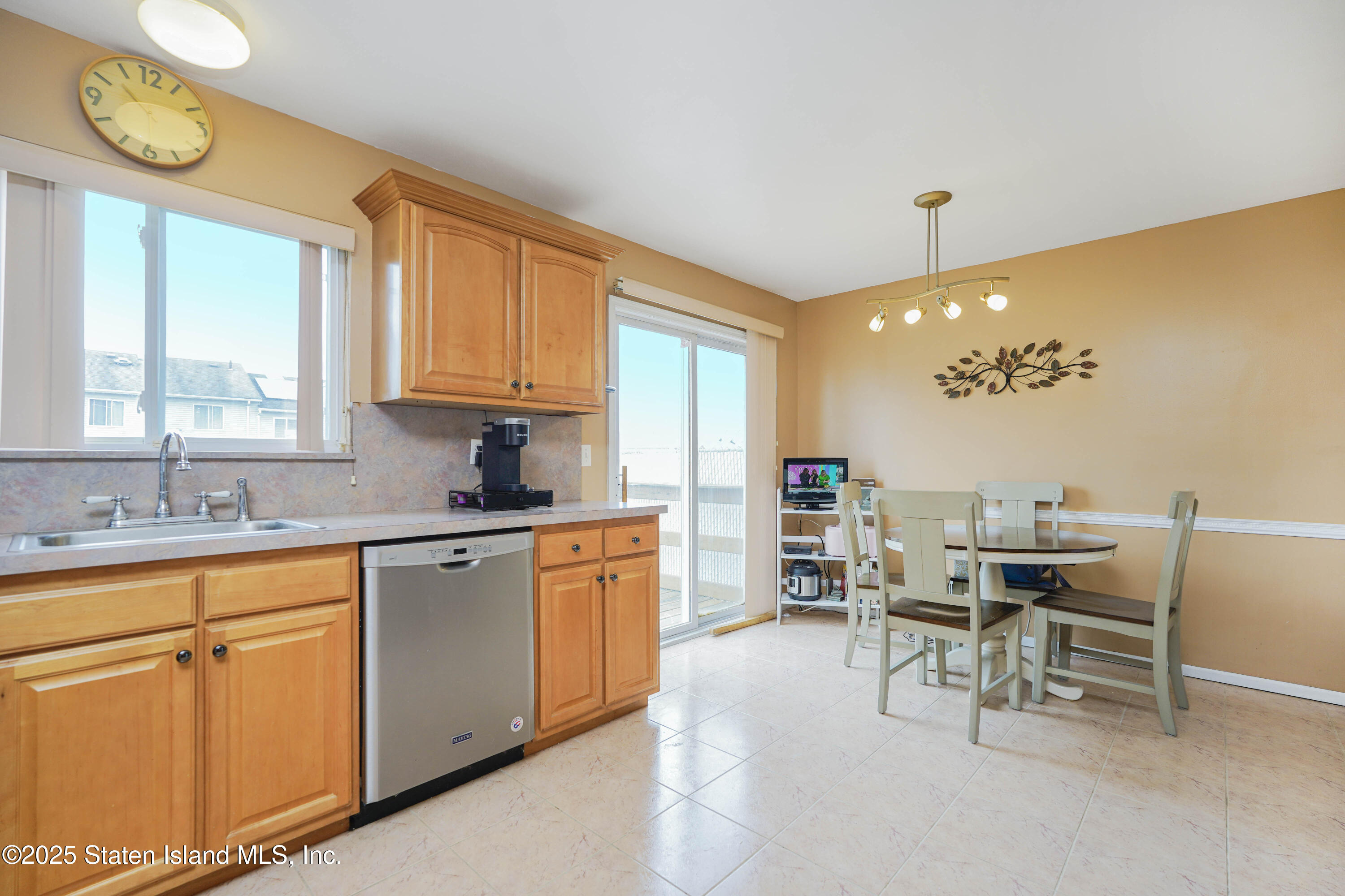 119 Glenn Road Staten Island, NY 10314 - Photo 6 of 26 a kitchen with stainless steel appliances granite countertop a table chairs sink and cabinets