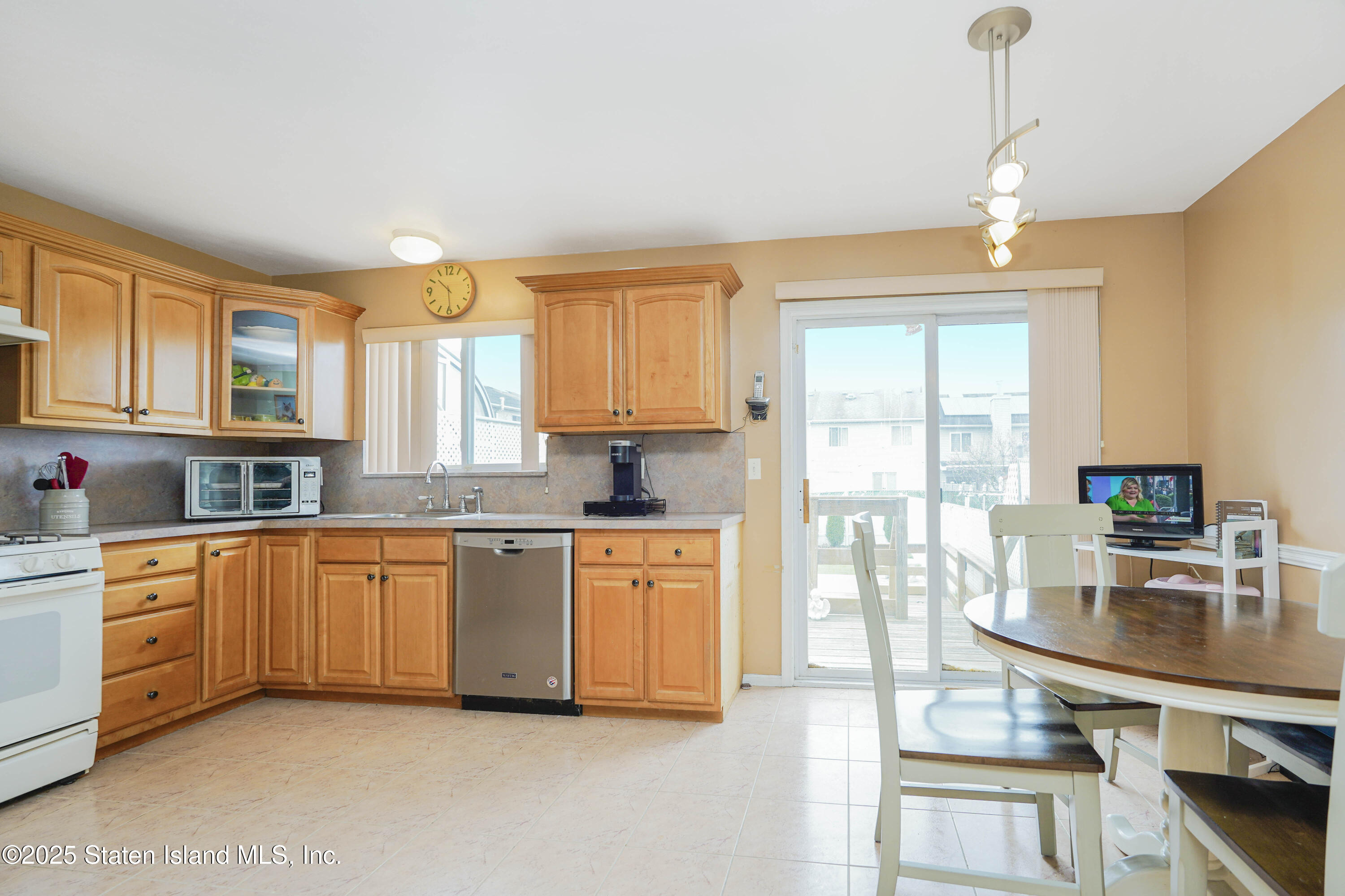 119 Glenn Road Staten Island, NY 10314 - Photo 7 of 26 a kitchen with stainless steel appliances granite countertop a stove refrigerator sink and cabinets