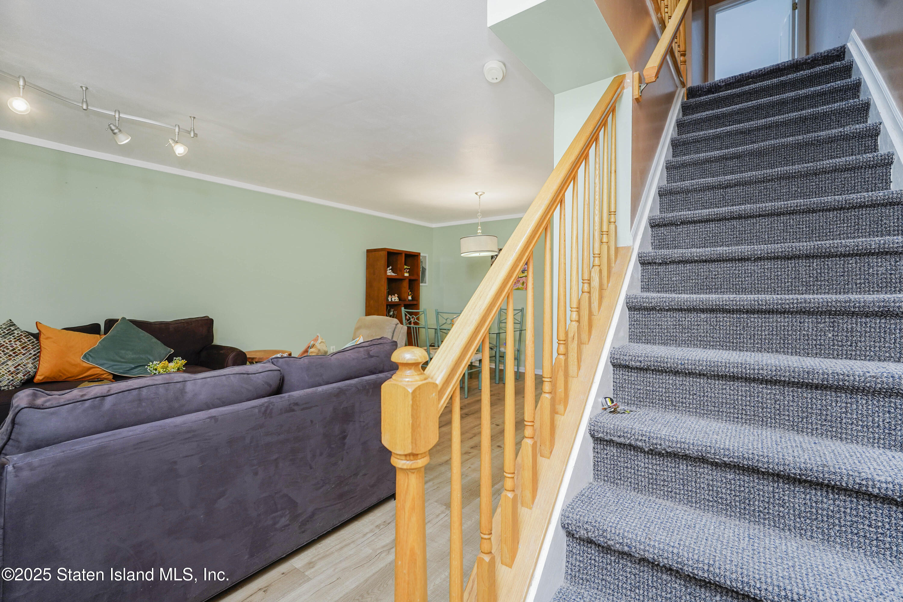 119 Glenn Road Staten Island, NY 10314 - Photo 10 of 26 a living room with furniture and stairs