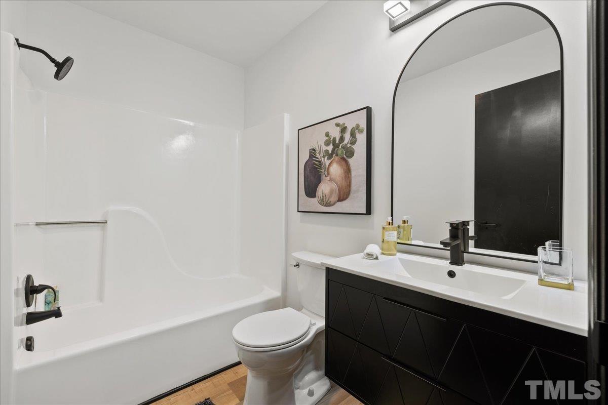 5816 Shannas Way Durham, NC 27713 - Photo 14 of 40 a bathroom with a sink and a mirror