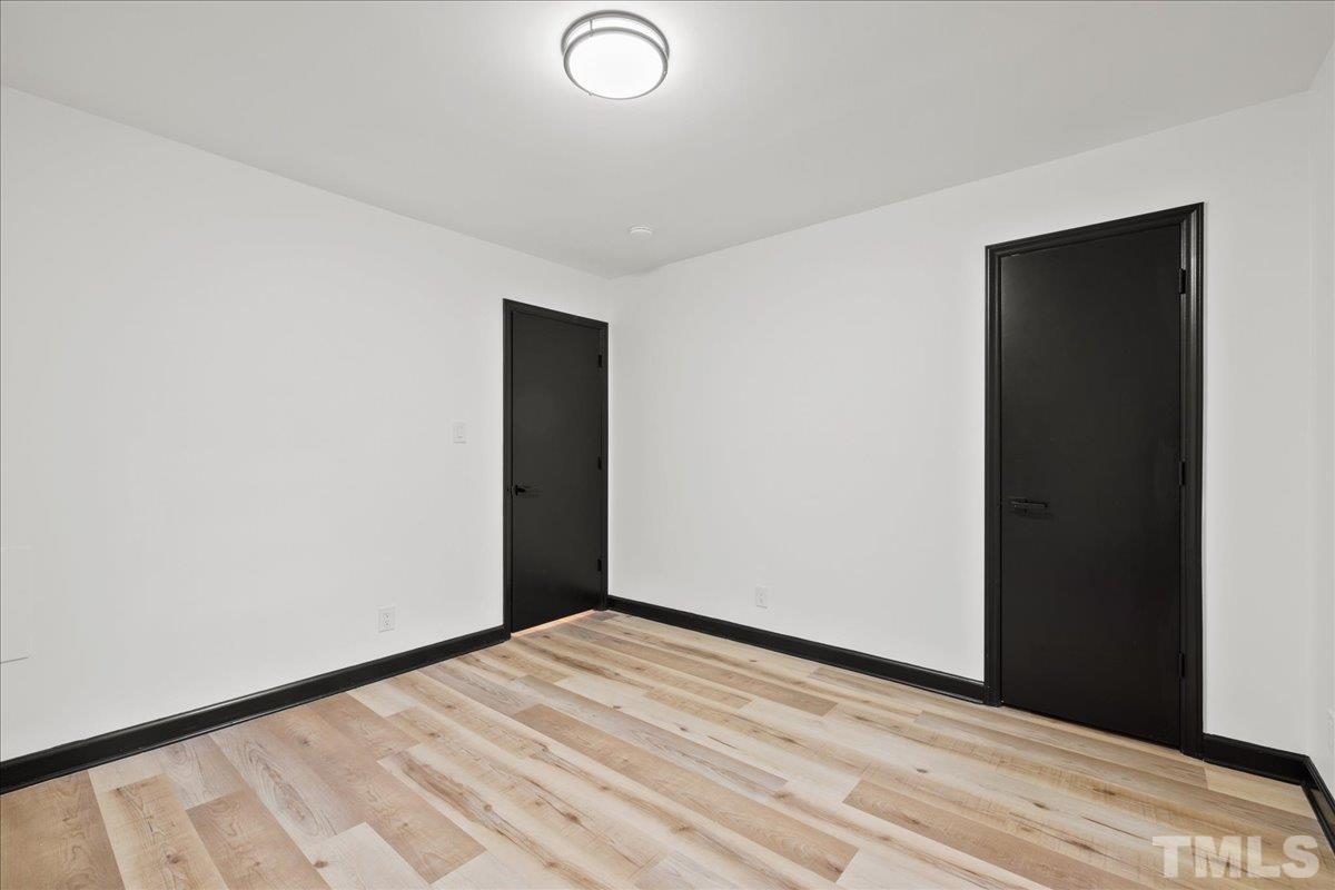 5816 Shannas Way Durham, NC 27713 - Photo 16 of 40 a view of empty room with wooden floor
