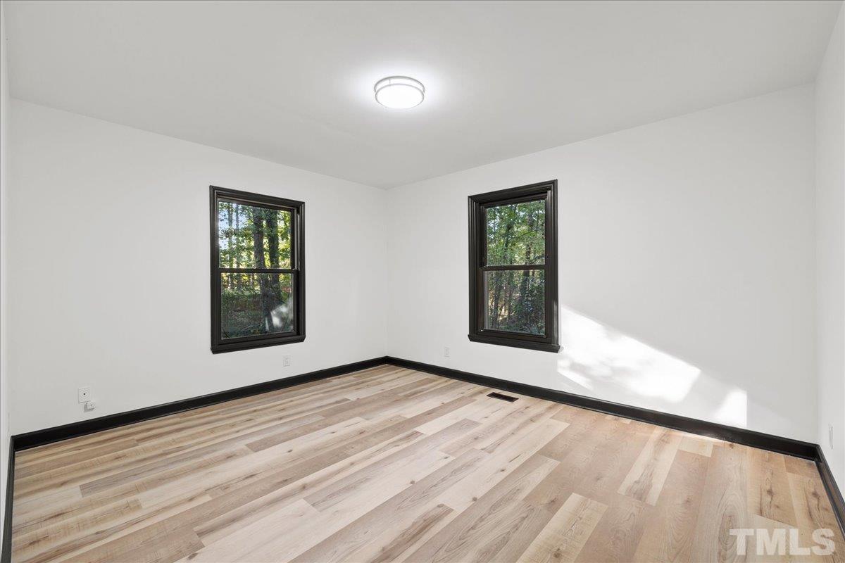 5816 Shannas Way Durham, NC 27713 - Photo 17 of 40 an empty room with windows