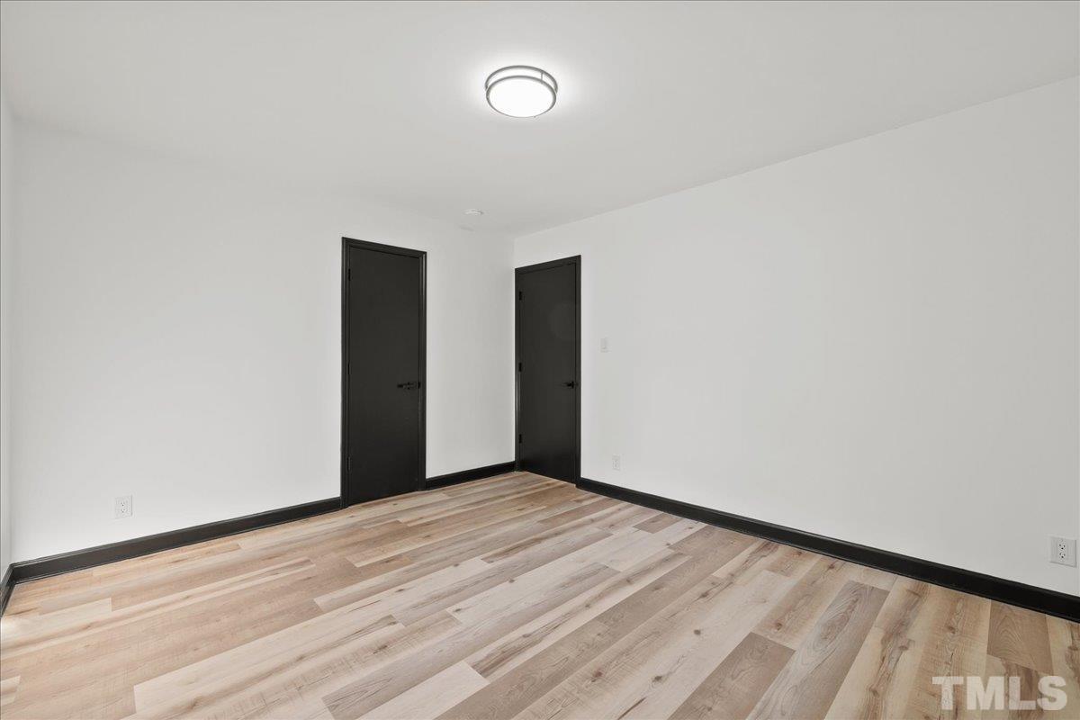 5816 Shannas Way Durham, NC 27713 - Photo 18 of 40 a view of an empty room with wooden floor