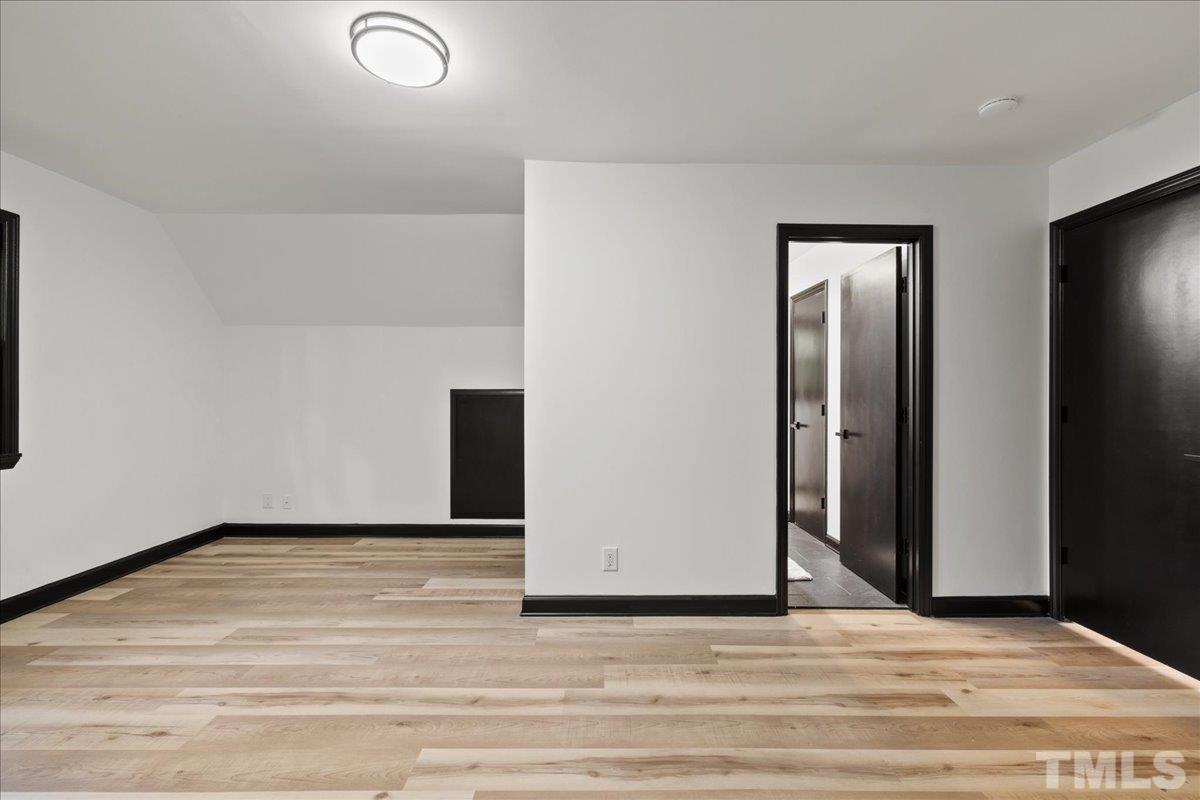 5816 Shannas Way Durham, NC 27713 - Photo 24 of 40 a view of an empty room with wooden floor
