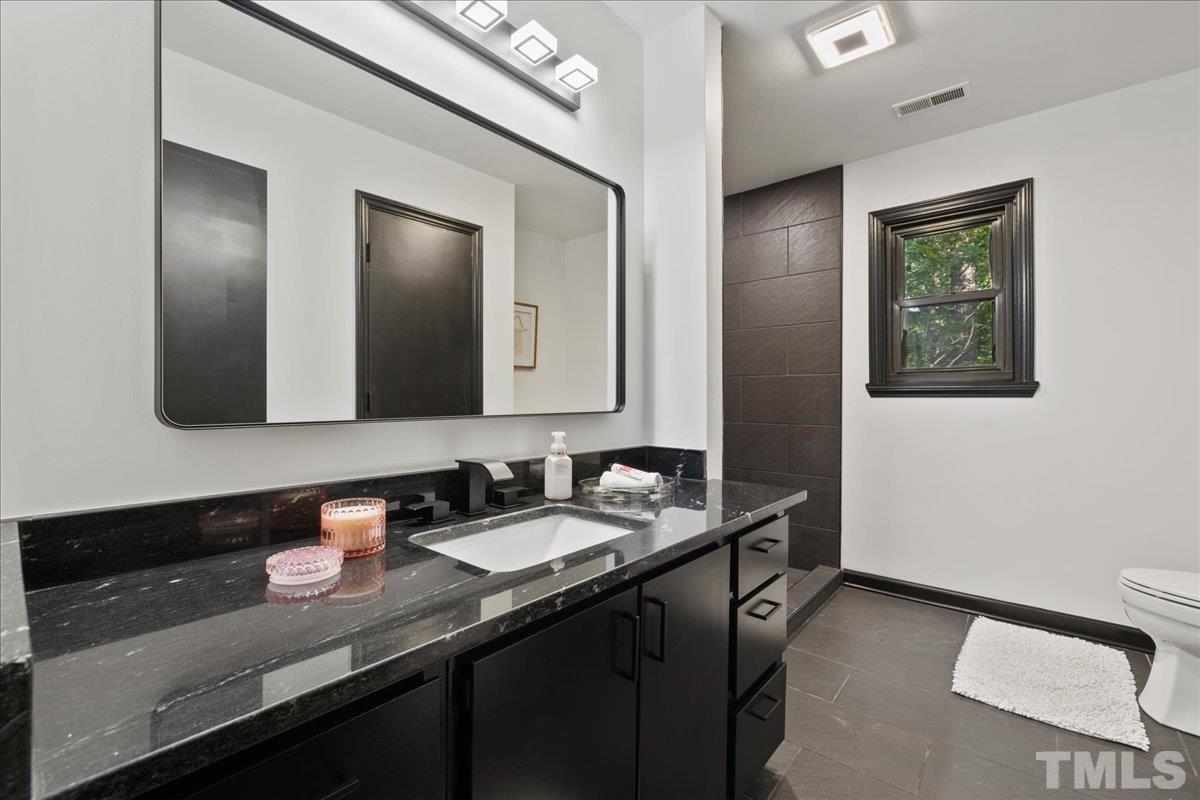 5816 Shannas Way Durham, NC 27713 - Photo 27 of 40 a bathroom with 2 sink and a mirror
