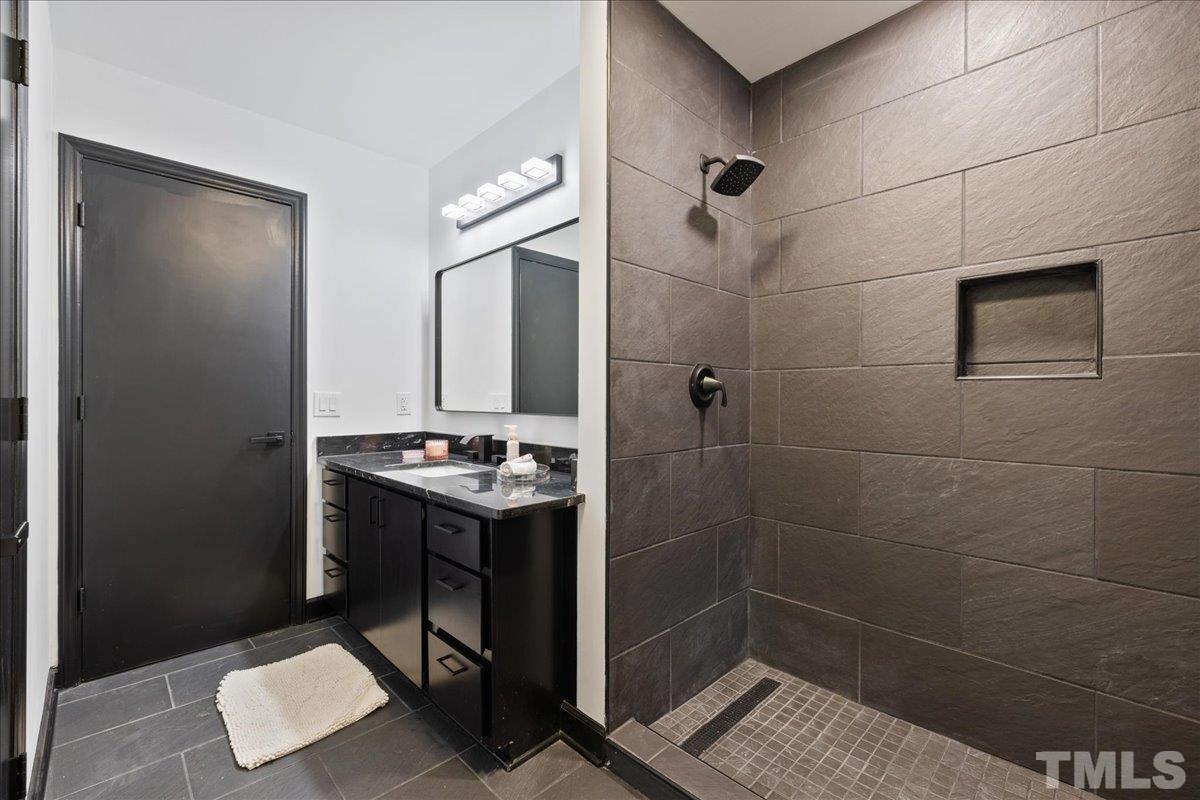 5816 Shannas Way Durham, NC 27713 - Photo 28 of 40 a bathroom with a shower toilet and sink