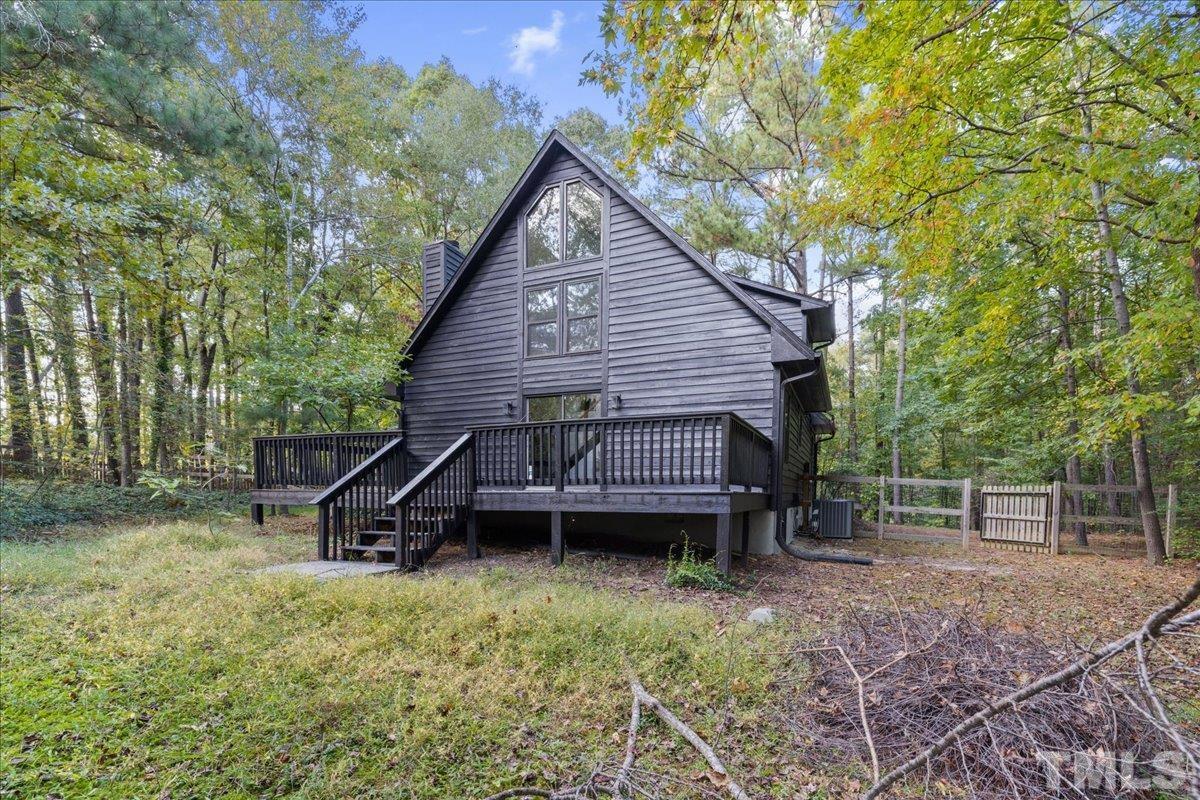 5816 Shannas Way Durham, NC 27713 - Photo 33 of 40 a view of a house with a wooden deck and a backyard