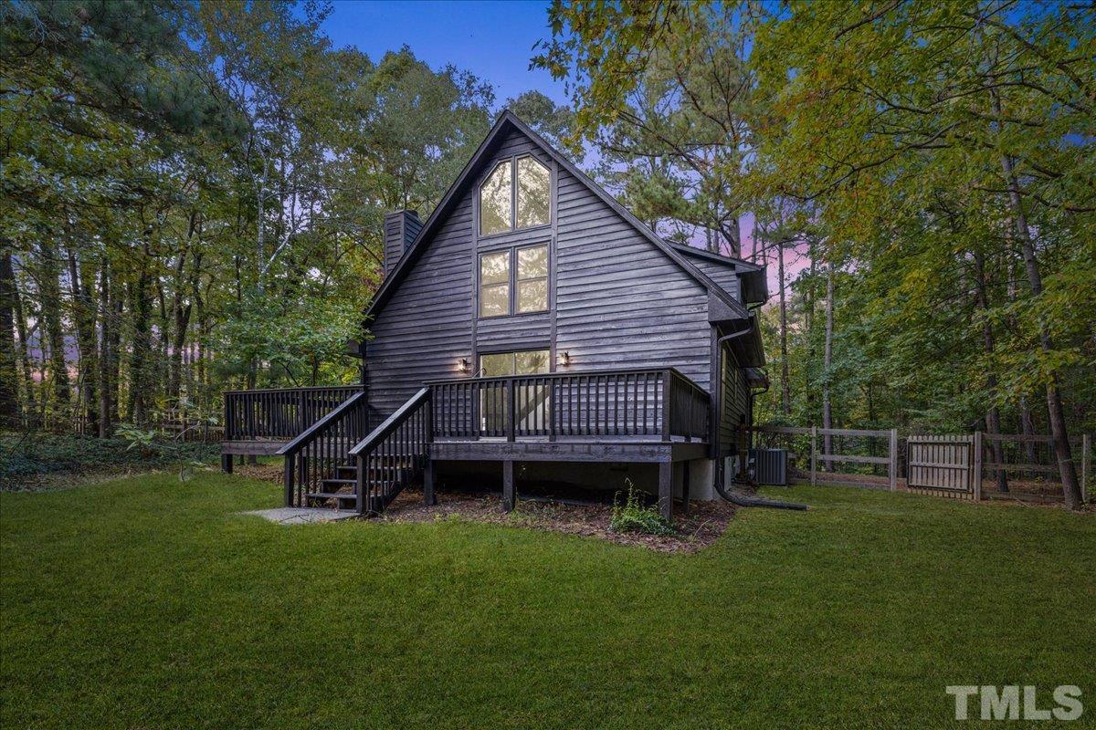 5816 Shannas Way Durham, NC 27713 - Photo 34 of 40 a view of a house with a backyard and wooden deck