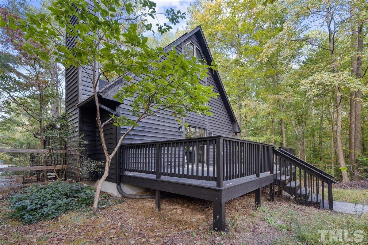 5816 Shannas Way Durham, NC 27713 - Photo 36 of 40 a view of a backyard with a small deck and wooden fence