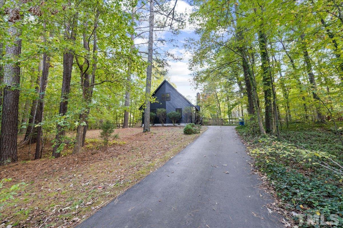 5816 Shannas Way Durham, NC 27713 - Photo 39 of 40 a view of a house with large trees and plants