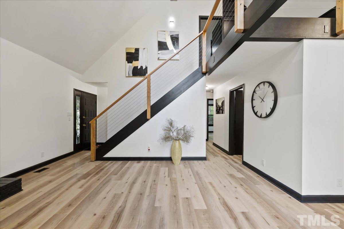 5816 Shannas Way Durham, NC 27713 - Photo 6 of 40 a view of a hallway with wooden floor