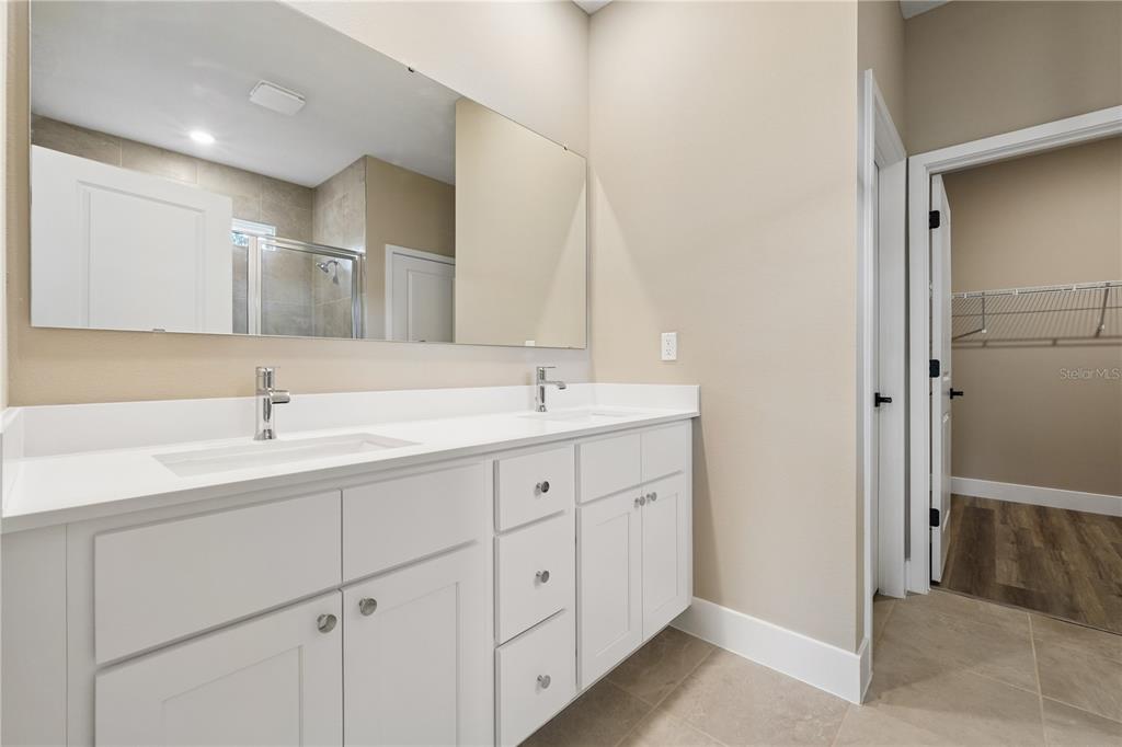 21 Postman Lane Palm Coast, FL 32164 - Photo 11 of 13 a spacious bathroom with double sink and a mirror
