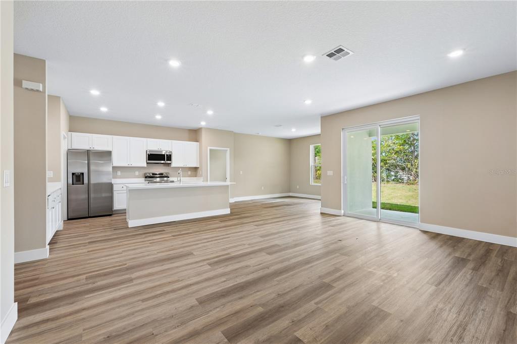 21 Postman Lane Palm Coast, FL 32164 - Photo 3 of 13 a view of kitchen with wooden floor and window