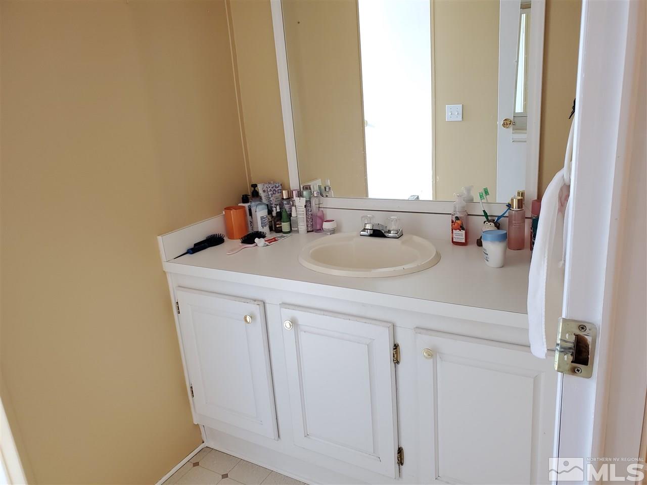 2146 Barberry Way Reno, NV 89512 - Photo 11 of 18 a bathroom with a sink a vanity and a mirror