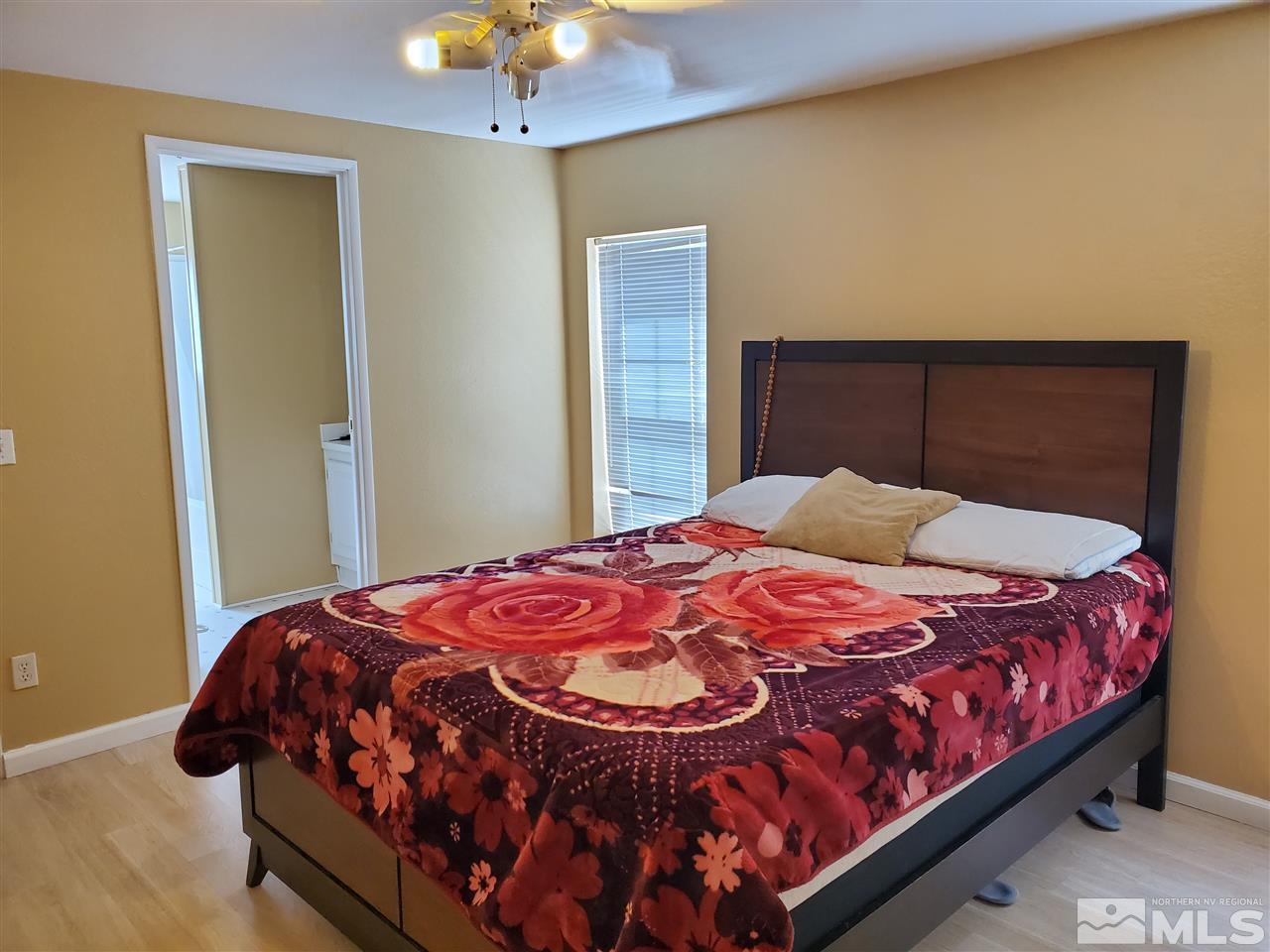 2146 Barberry Way Reno, NV 89512 - Photo 12 of 18 a bedroom with a bed and a chandelier