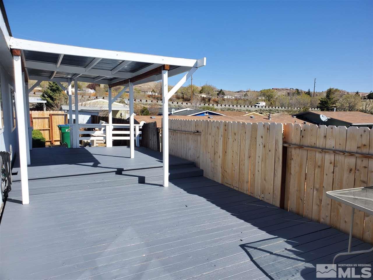 2146 Barberry Way Reno, NV 89512 - Photo 14 of 18 a view of a patio with table and chairs with wooden floor and fence