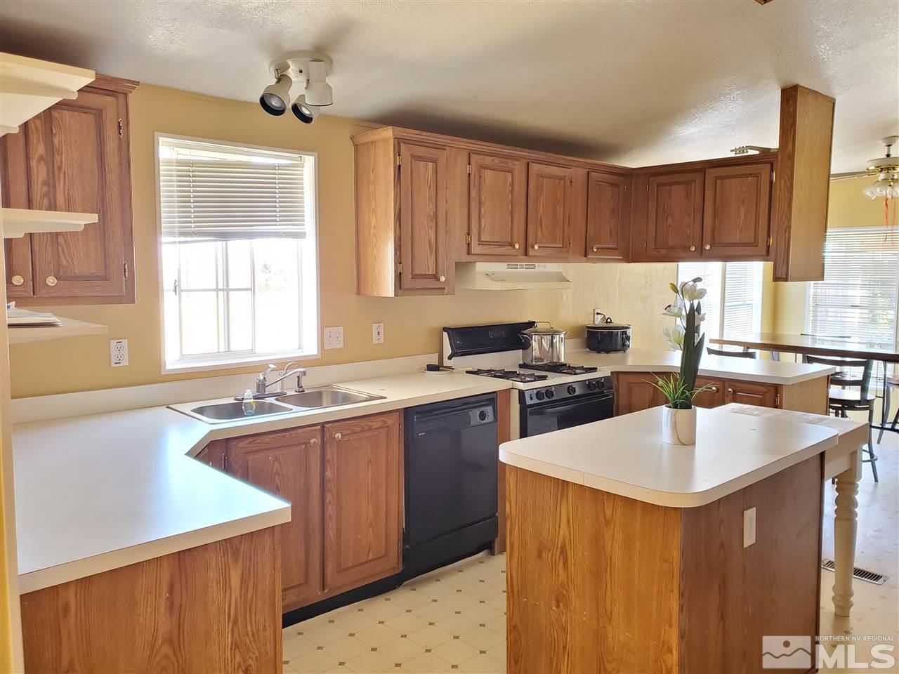 2146 Barberry Way Reno, NV 89512 - Photo 2 of 18 a kitchen with a sink stove top oven and cabinets