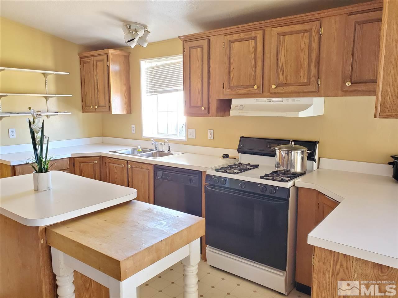 2146 Barberry Way Reno, NV 89512 - Photo 3 of 18 a kitchen with stainless steel appliances granite countertop a sink stove and refrigerator